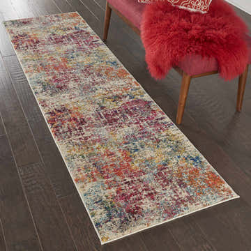 Hallway scene with a Nourison Celestial Pink Multicolor runner rug on dark wood floors.