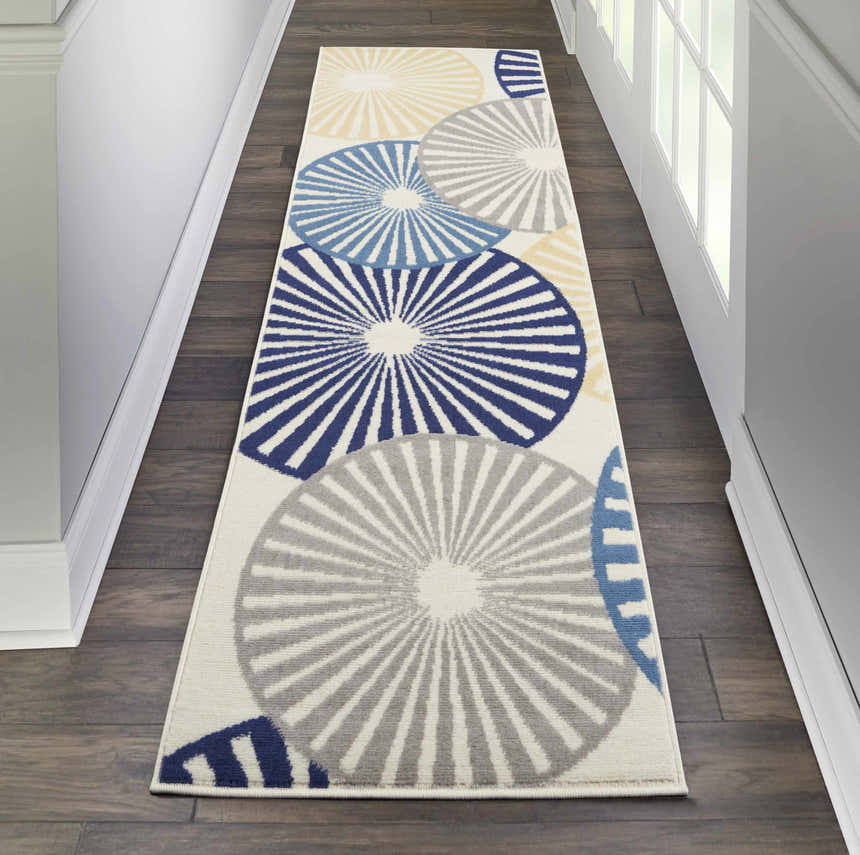 Hallway scene with Nourison Grafix White rug runner featuring blue, gray, and yellow circle pattern on dark wood floors.