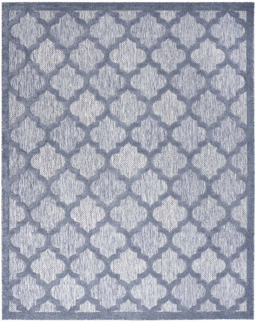 Close-up of the Nourison Easy Care Denim Blue rug, featuring a quatrefoil pattern and a textured, machine-made weave.