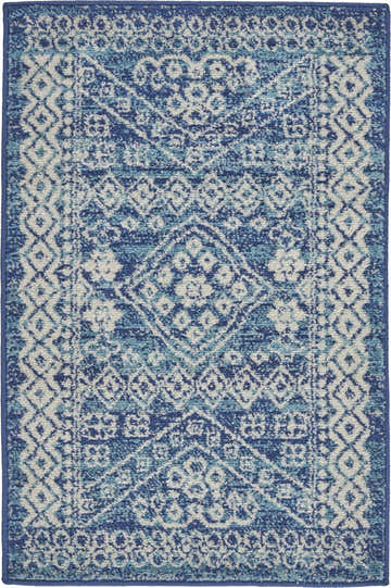 Close-up of the Nourison Passion Navy Blue rug. Features a bohemian diamond pattern in shades of navy, blue, and white.
