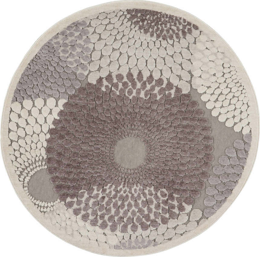 Close-up of round Nourison Graphic Illusions rug. Gray, taupe, and cream abstract floral-like pattern. Mid-century modern style.