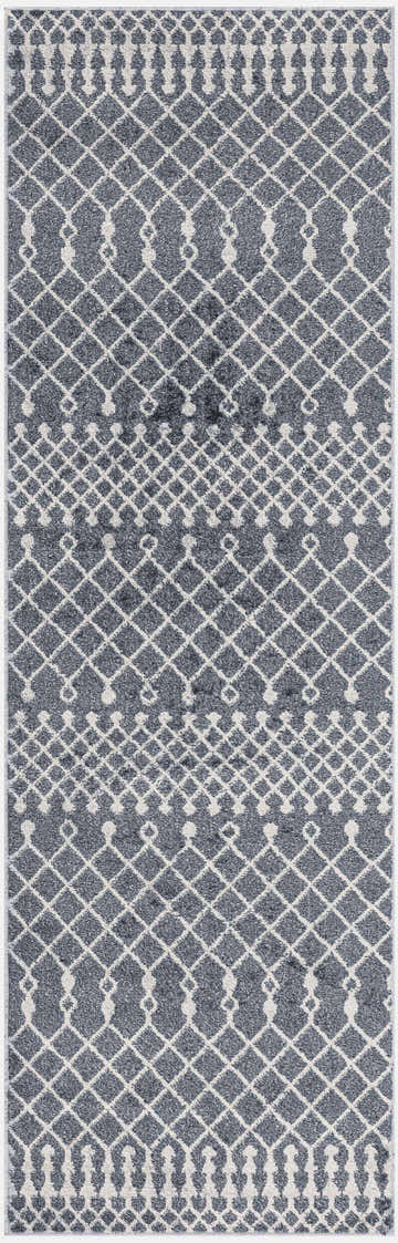 Close-up of Nourison Astra Denim Rug. Machine-made rug features a geometric diamond pattern in denim and ivory. Washable area rug.