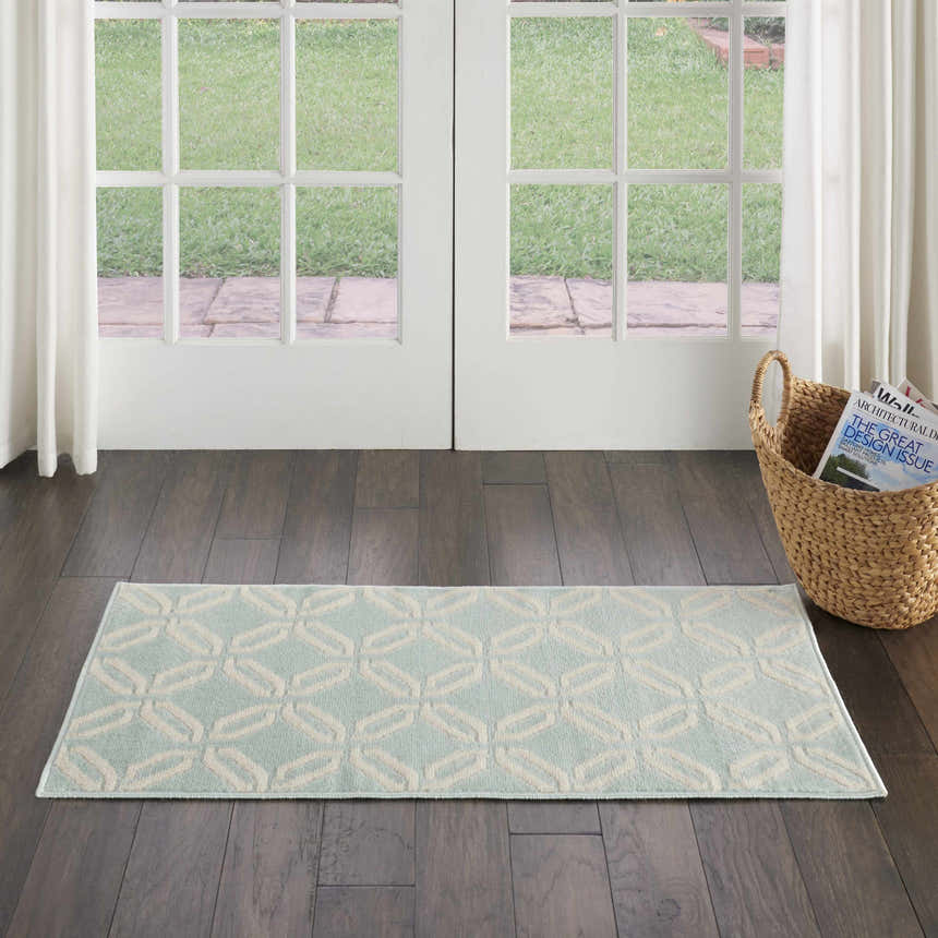 Entryway with Nourison Jubilant Green rug. Coastal style runner rug with geometric pattern on dark wood floors.