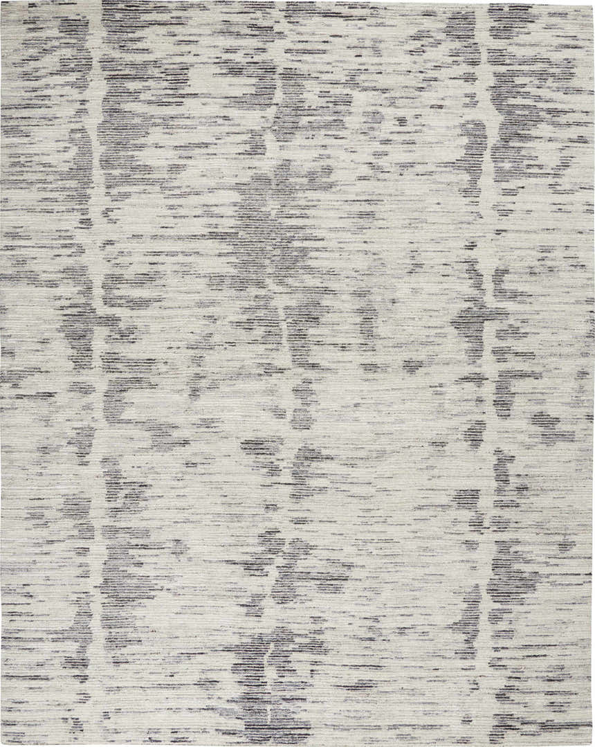 Close-up of Nourison OCEAN Cream Charcoal rug. Handmade, mid-century modern style with taupe tones and a subtle linear pattern.