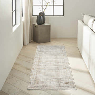 Modern living room with a Calvin Klein CK078 Summit Natural Ivory rug, light wood floors, and neutral furniture.