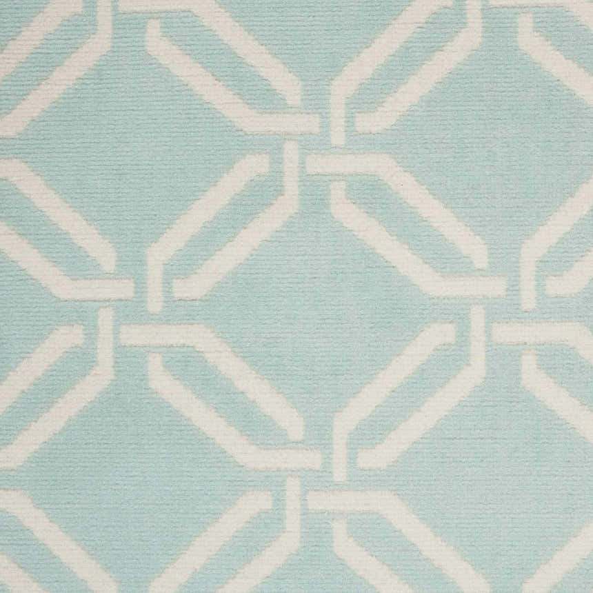Close up of Nourison Jubilant Green rug, featuring a geometric white pattern on a soft green background. Coastal style.