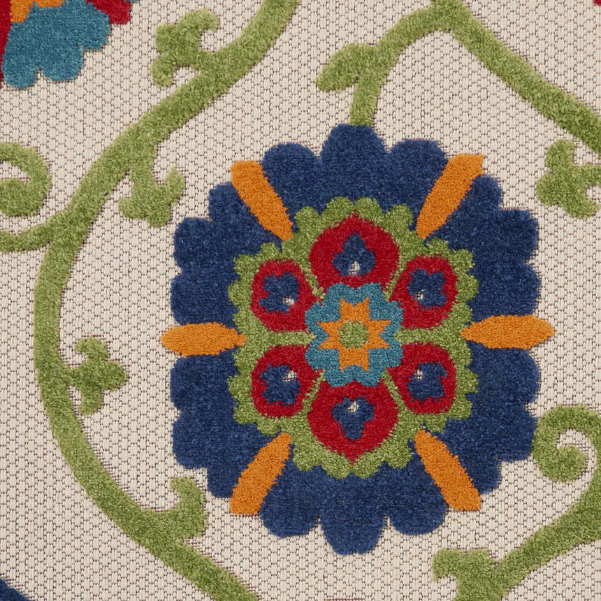 Close-up of the Nourison Aloha Blue Multicolor rug. Floral pattern with blue, red, green, and orange on a textured beige background.