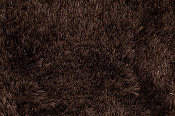 Close-up of the plush texture of the Feizy Indochine Modern Solid Brown Area Rug. Texture