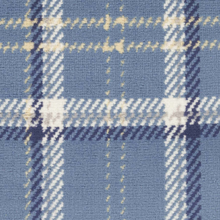 Close-up of the Nourison Grafix Blue Rustic Indoor Area Rug with a light blue, white, and navy plaid design.