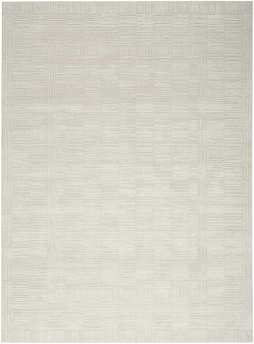 Close-up of the Nourison Dew Beige Rug, a low pile, machine-made rug with a subtle geometric pattern.