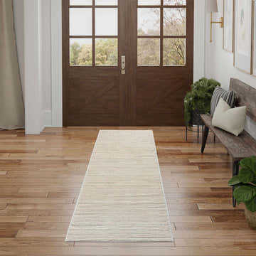 Entryway with Nourison Andes Ivory Grey Rug runner, wood floors, bench, and chestnut-colored double doors.