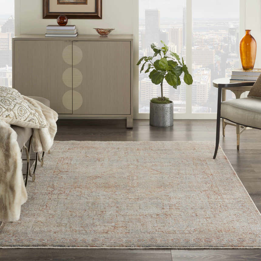 Living room scene with a grey brick Nourison Lustrous Weave rug, beige furniture, and a cityscape view. Vintage style.