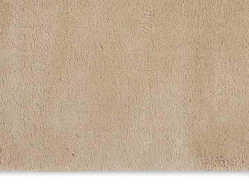 Close-up of the plush texture and beige color of the Calvin Klein Brooklyn area rug.