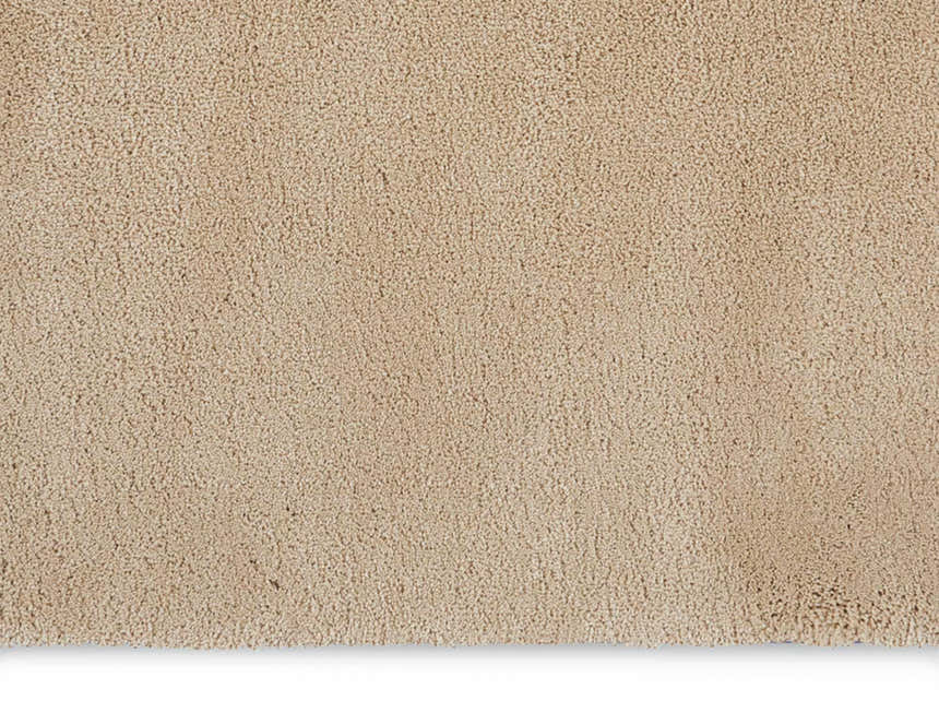 Close-up of the plush texture and beige color of the Calvin Klein Brooklyn area rug.