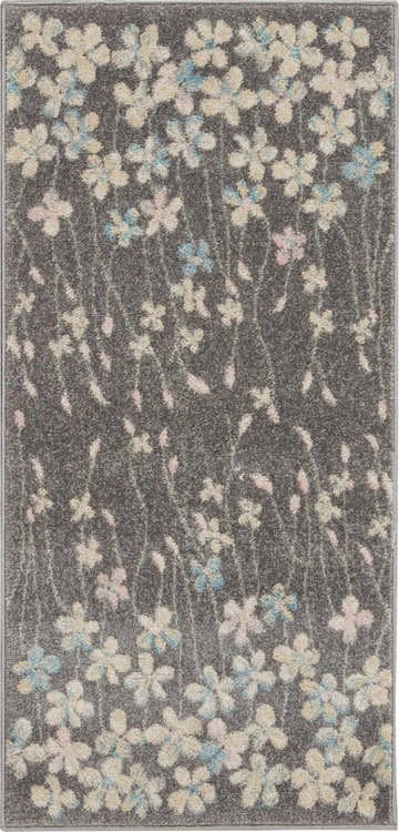 Close-up of Nourison Tranquil Grey Beige rug with a floral pattern in cream, pink, and blue on a textured gray background.