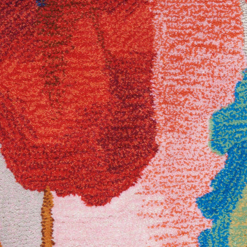 Close up of the Nourison Symmetry Multicolor Rug, featuring a bold, abstract design in red, pink, and blue.
