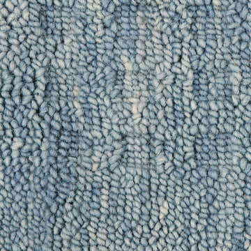 Close-up of the textured, handmade Nourison Marana Denim area rug. The rug is 100% wool and cotton.