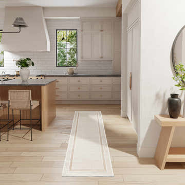 Light and airy kitchen with Nourison Glitz Ivory Cream rug runner, wood floors, island, and cream cabinets.