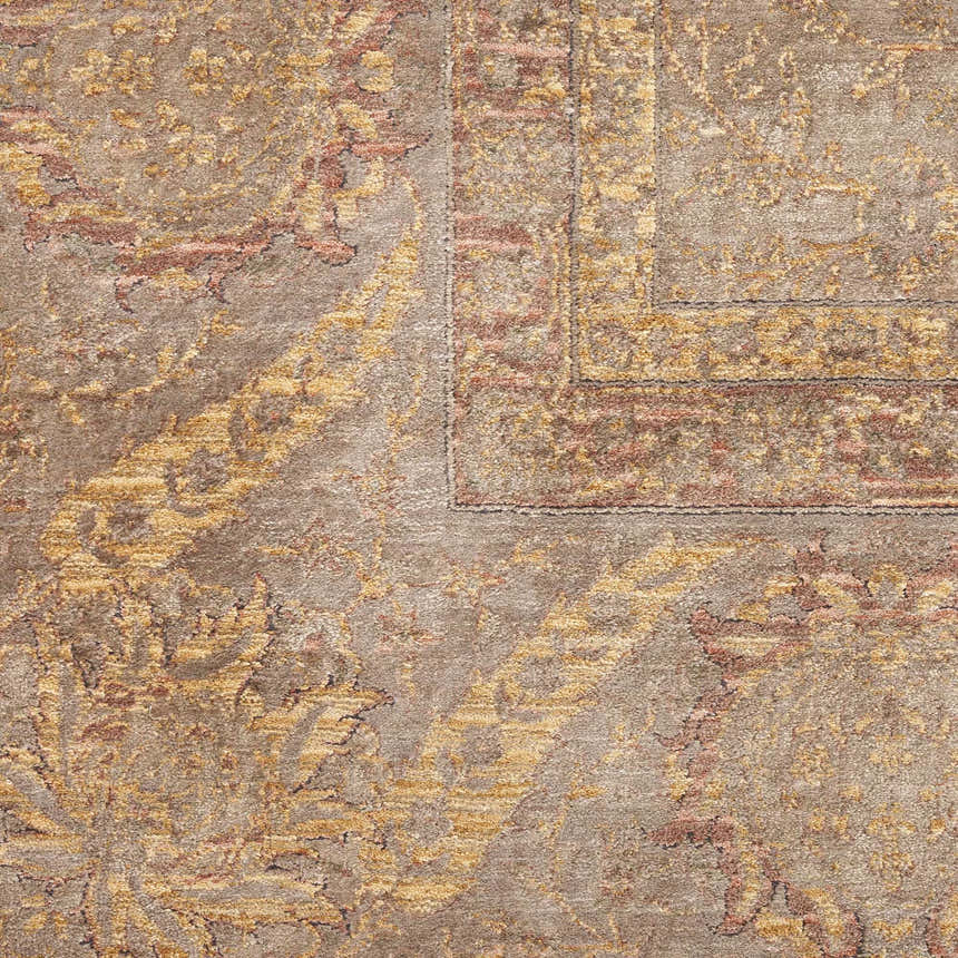 Close-up of the Nourison Luxurious Taupe Vintage Indoor Area Rug showing its ivory, gold, and coral distressed pattern.