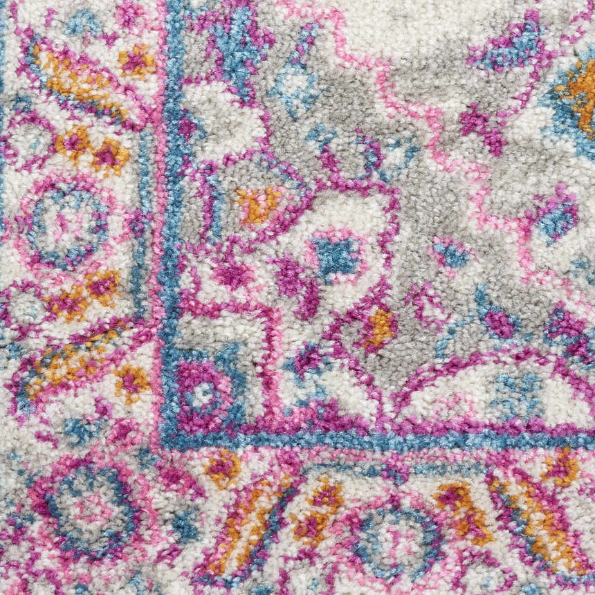Close-up of the Nourison Passion Light Grey Pink Bohemian Indoor Area Rug, showing its texture and colorful pattern.