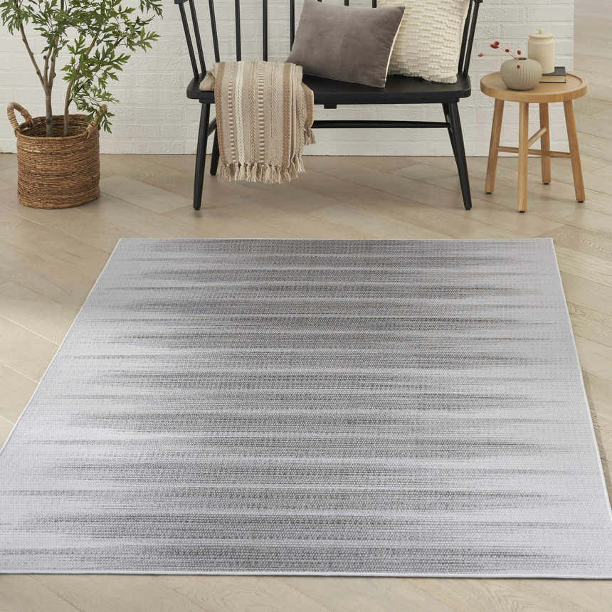 Modern living room scene with a grey Nourison Vintage Home area rug.