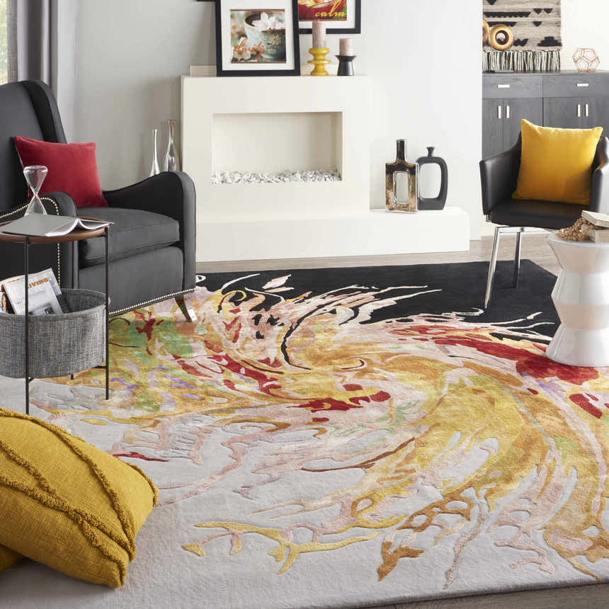 Living room scene with a Nourison Prismatic Multicolor rug, gray chairs, fireplace, and pops of red and yellow accents.