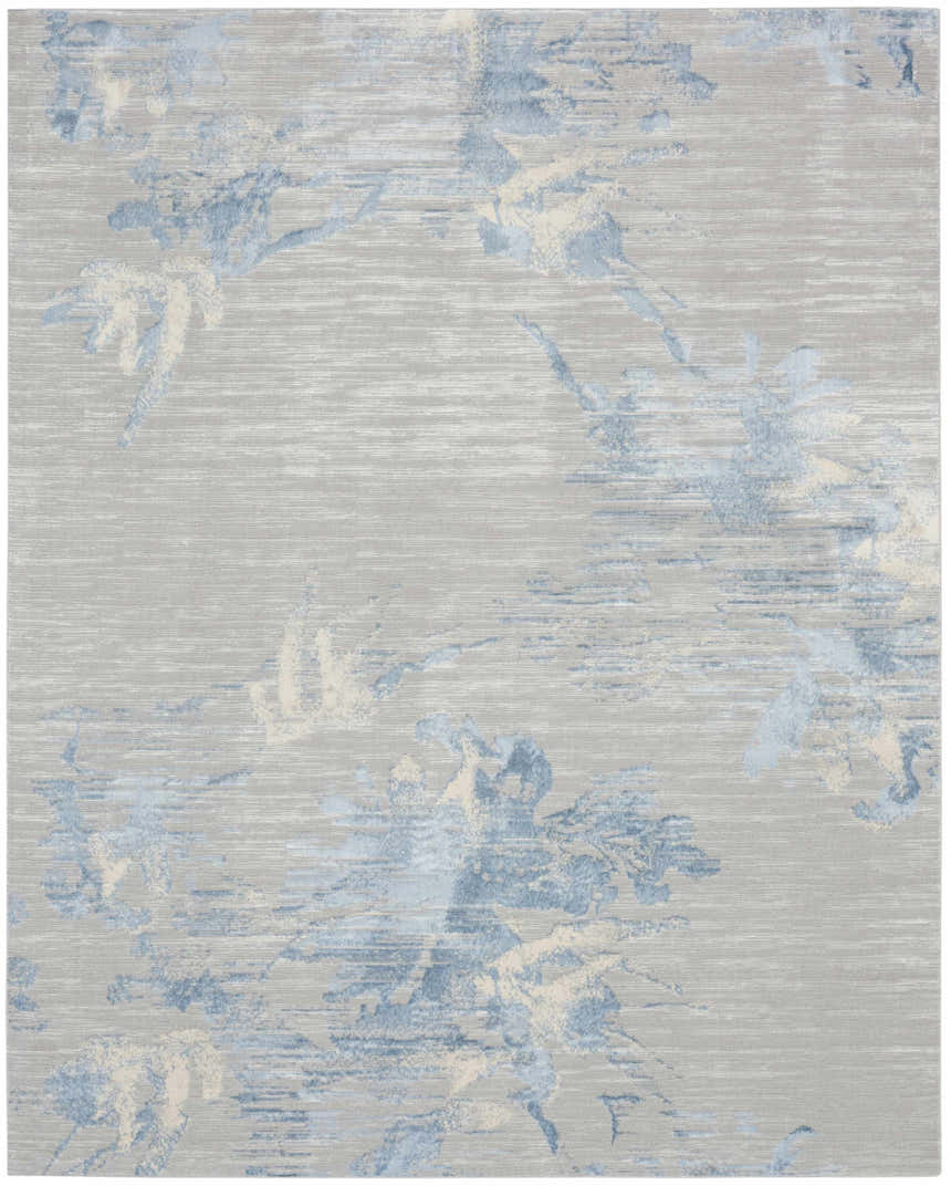 Close-up of Calvin Klein CK005 Enchanting Grey Sky rug. Contemporary high pile with blue and cream floral pattern.