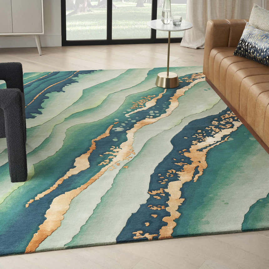 Living room scene with a Nourison Prismatic Emerald rug, light green, blue and gold abstract design, tan sofa.