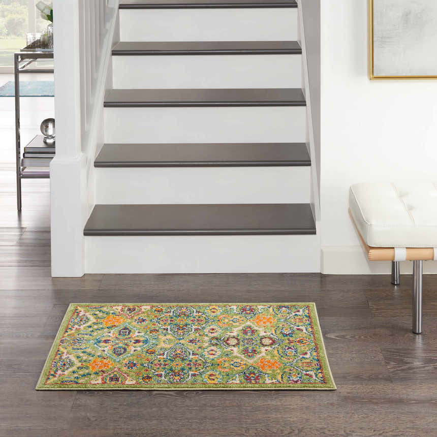 Hallway scene with the Nourison Allur Sage Ivory rug, wood floors, white stairs, and a modern white bench.