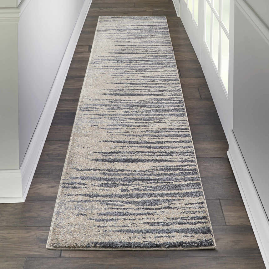 Hallway with Nourison Moroccan Celebration Blue Beige runner rug on dark wood floor.
