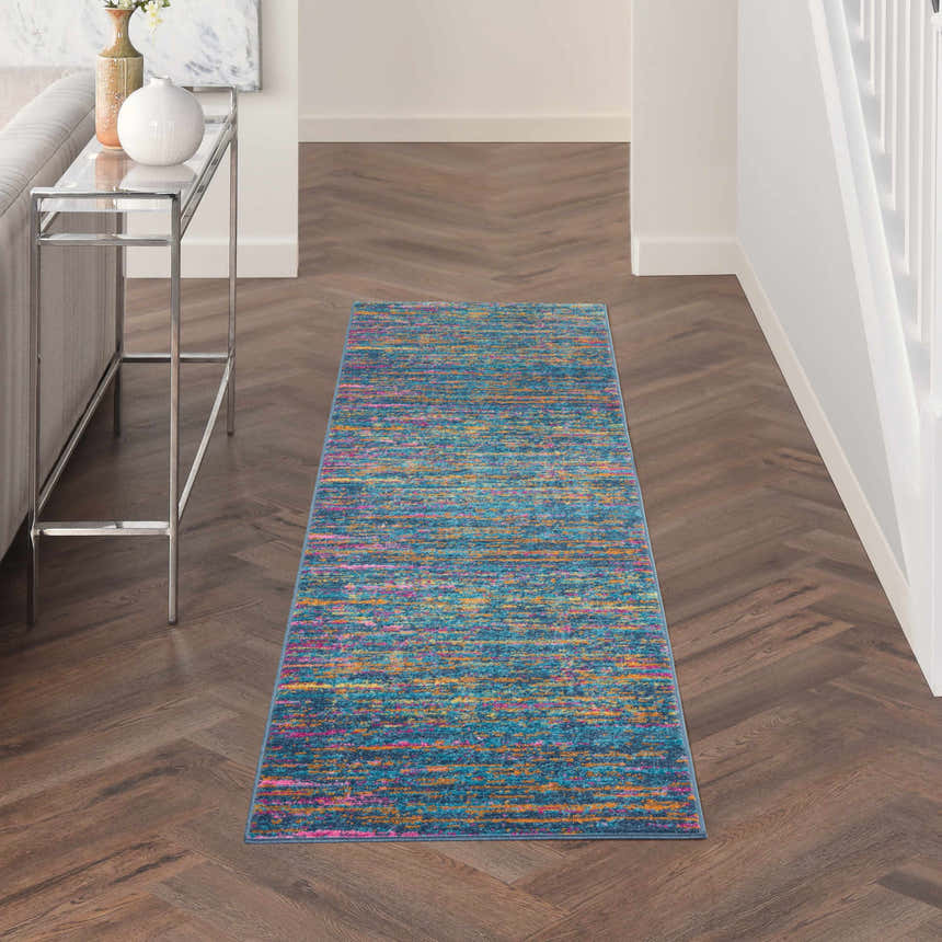 Hallway with Nourison Passion Blue Multicolor runner rug, wood floors, white walls, and console table.