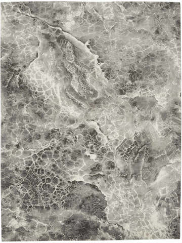 Close-up of the Calvin Klein Gradient Grey rug, showing a marbled pattern in shades of gray and white.