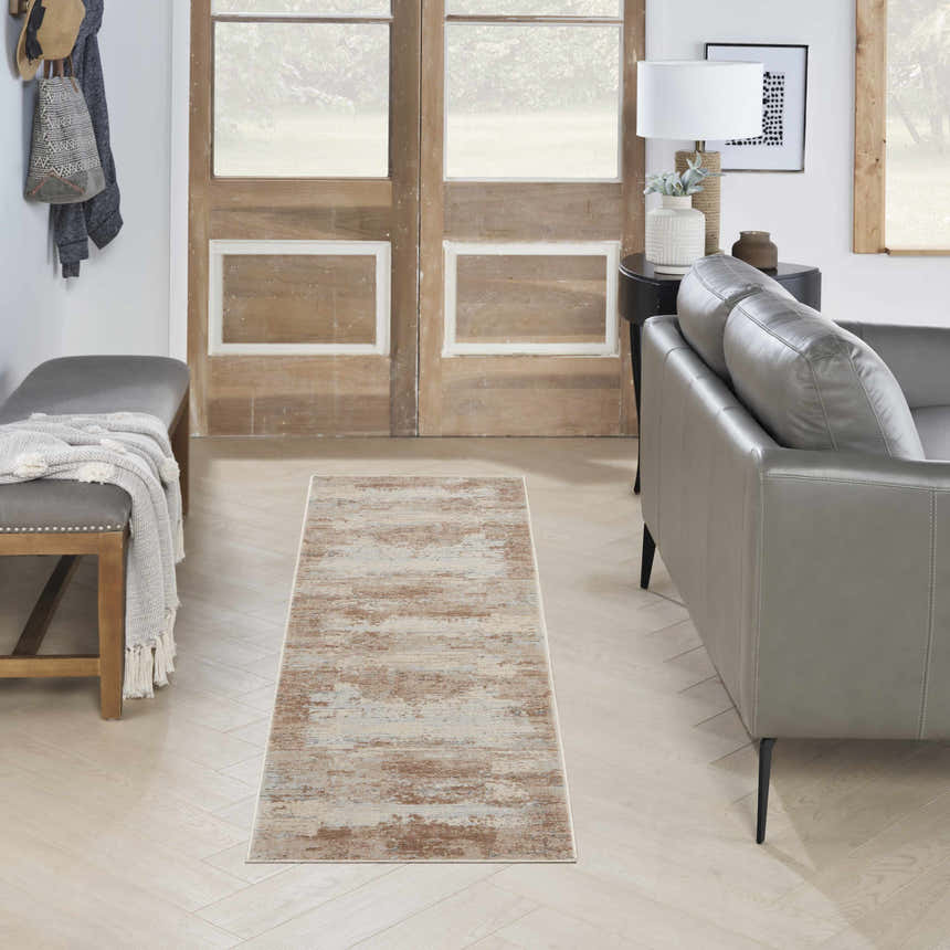 Entryway with a gray leather sofa and Nourison Rustic Textures Beige Modern Indoor Area Rug runner on light wood floors.