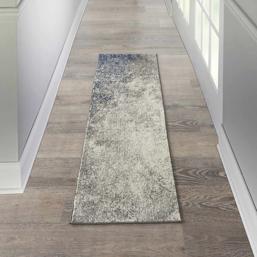 Hallway scene with Nourison Passion Charcoal Ivory rug runner on wood floor, white walls and door.