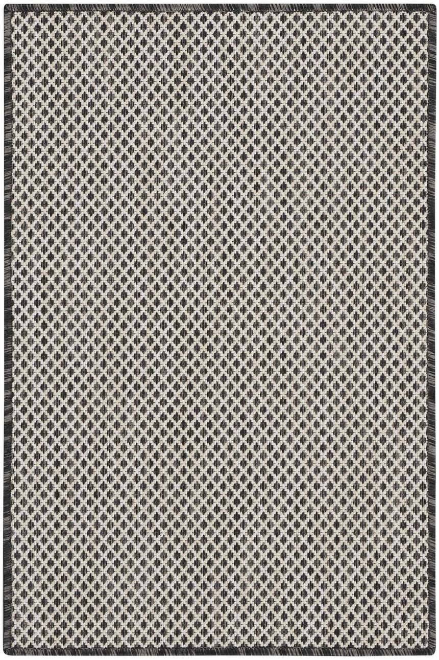 Close-up of the Nourison Courtyard Ivory Charcoal rug, featuring a diamond pattern and textured weave.