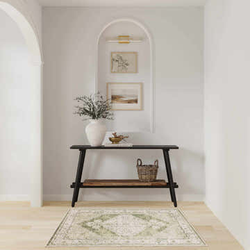 Entryway with a Nourison Astra Ivory Green Vintage rug under a console table.