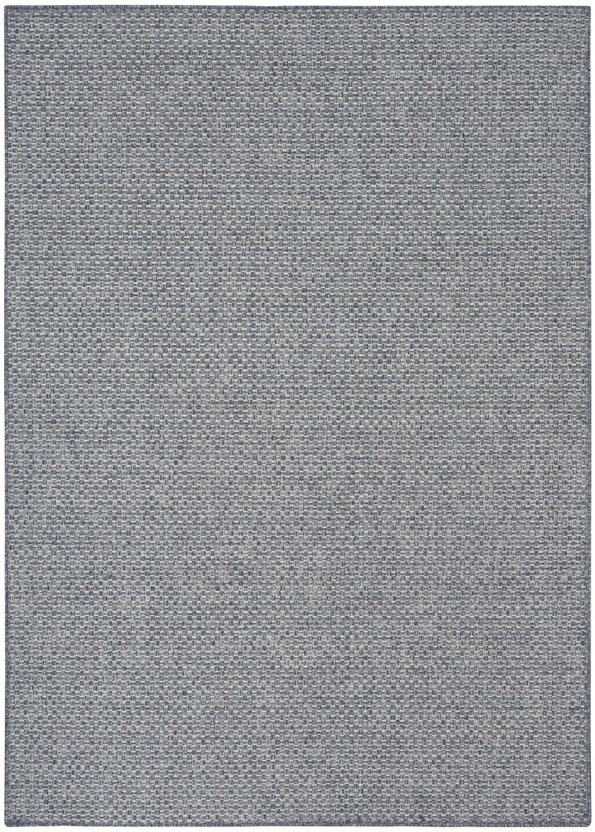 Close-up of the Nourison Tulum Denim Outdoor Area Rug, showing a woven texture in shades of blue and gray.