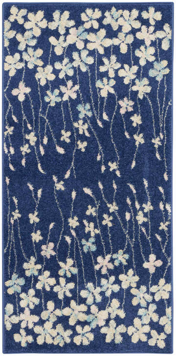 Close-up of the Nourison Tranquil Navy rug. Features a floral pattern with cream, pink, and blue flowers on a navy background.