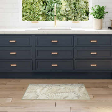 Modern kitchen with navy cabinets and Nourison Aloha Ivory Sage Area Rug.