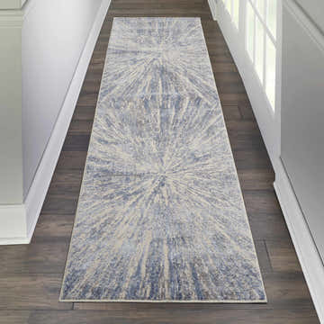 Hallway with Nourison Silky Textures Blue Grey runner rug, modern starburst pattern, on dark wood floors.