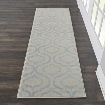 Nourison Jubilant Ivory Blue Runner rug on dark wood floor. Contemporary quatrefoil pattern.