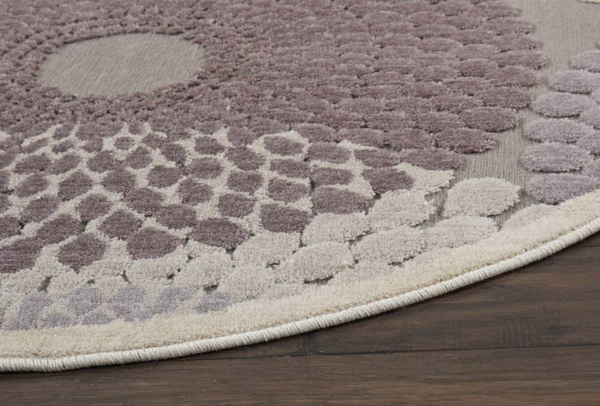 Close-up of Nourison Graphic Illusions Grey rug with a textured, dotted mid-century modern pattern on dark wood floor.