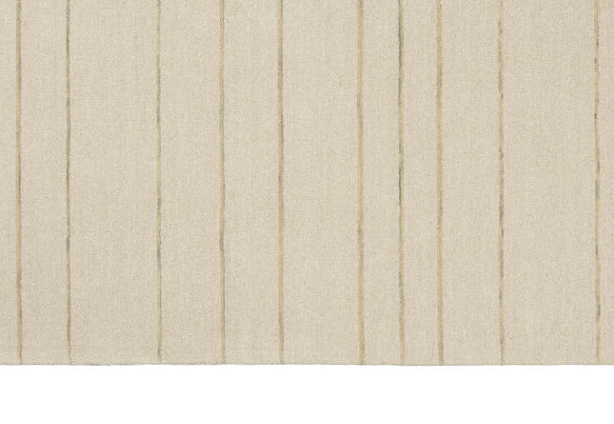 Close-up of the Calvin Klein Halo Ivory rug. Wool rug with subtle chestnut vertical stripes, handmade construction.
