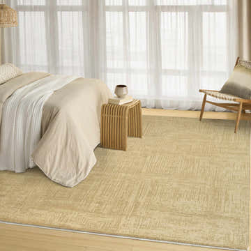 Serene bedroom with DKNY DK014 Madison Taupe rug, wood accents, and soft ivory textiles creating a calm, mid-century modern feel.