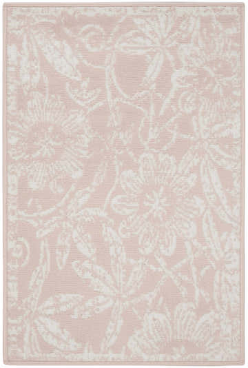 Close-up of the Nourison Whimsicle Pink Farmhouse Indoor Area Rug featuring a floral pattern in light pink and white.