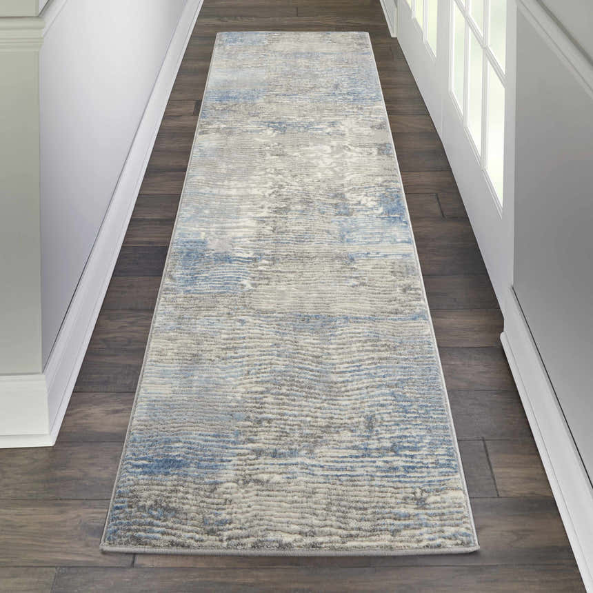 Hallway scene with a Nourison Solace Ivory Grey Blue runner rug on dark wood floors. White trim and doors.