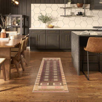 Modern kitchen and dining area with a Nourison Nordic Rust runner rug on wood floors.