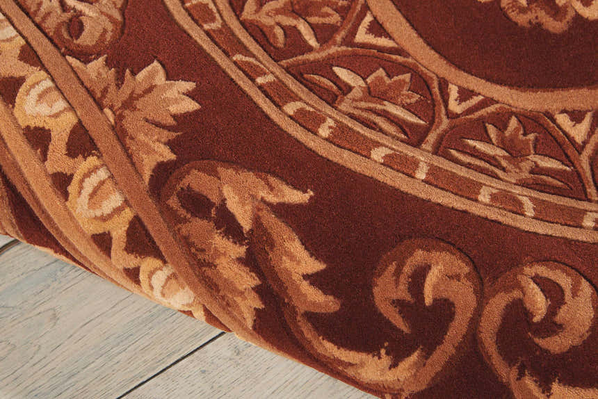 Close up of the brick red Nourison Versailles Palace rug showing wool texture and floral pattern.