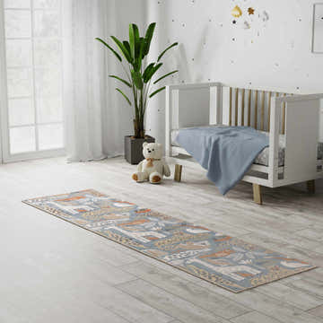 Nursery with a white crib and Nourison Astra Multicolor Kids Rug featuring animal motifs.