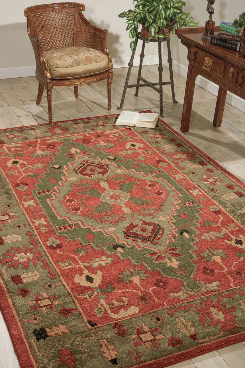 Traditional living room scene with a Nourison Tahoe Rust area rug, wood chair, and accent table.
